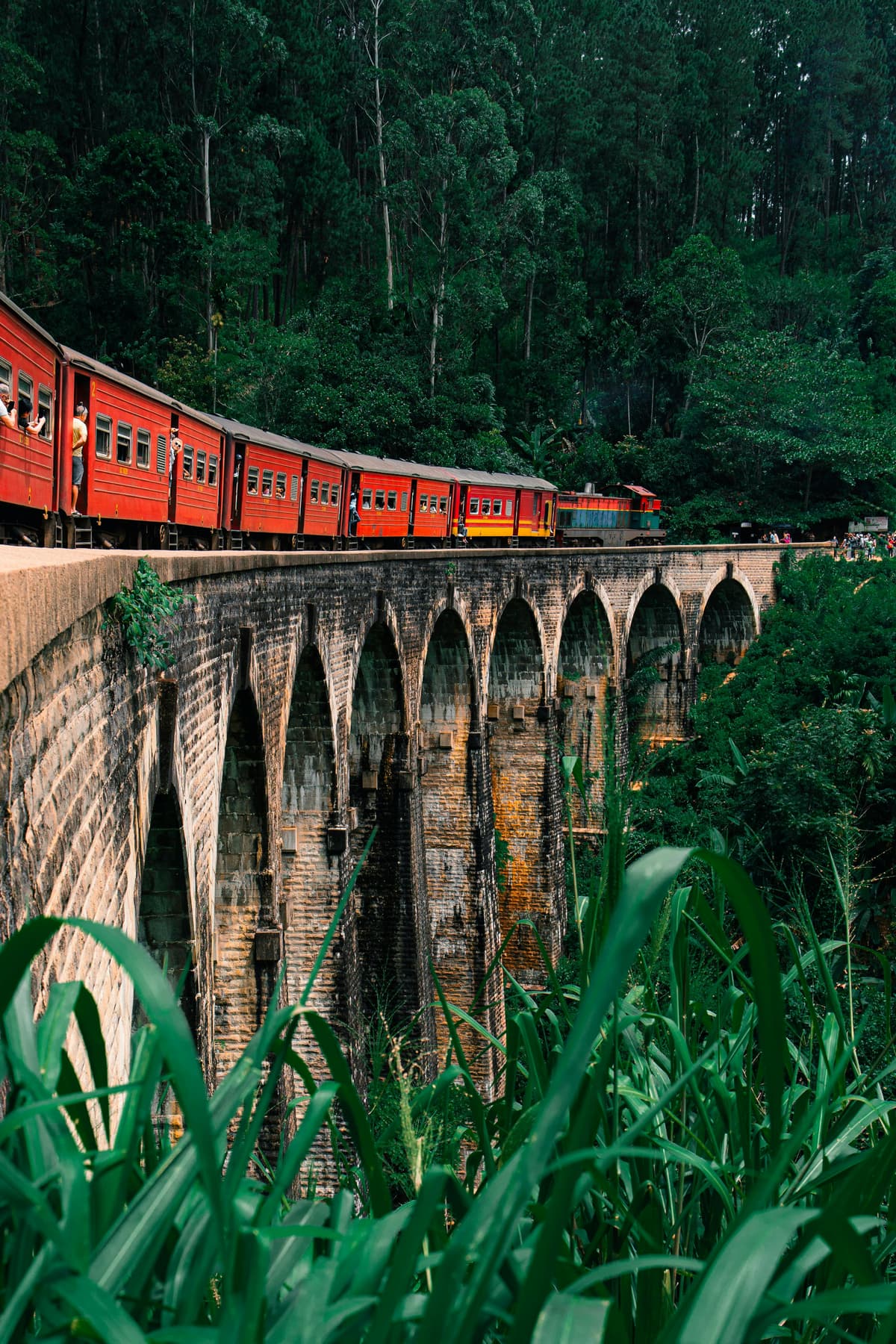 The red hill-country train crossing the Nine Arch Bridge near Ella