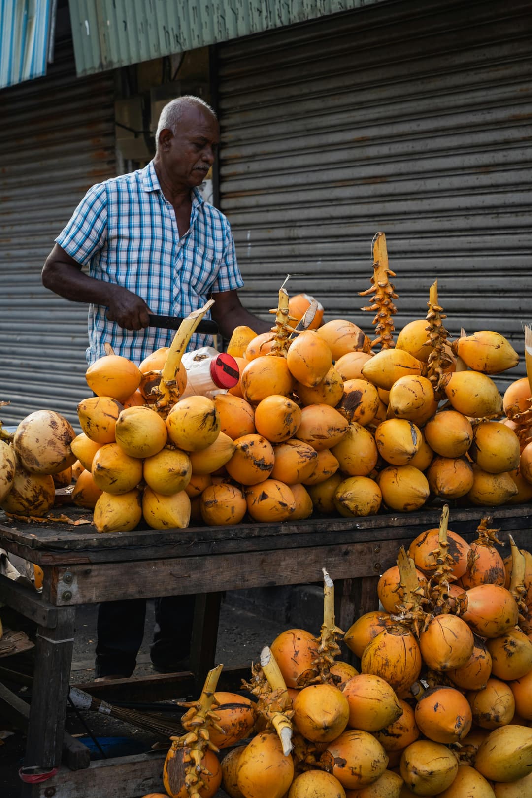King coconut vendor at a street stall in Colombo